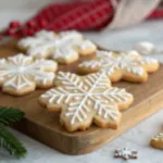 Winter-themed cinematic dessert video of Snowflake Cookies. Rustic wooden table, soft snowfall effect, twinkle lights in the background. Close-ups of dough rolling, cookie cutting, icing piping, and powdered sugar dusting. Final plating: cookies arranged on a decorative holiday plate with a winter backdrop. Warm lighting, cozy festive mood, high realism, professional dessert videography.