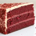 Air Fryer Red Velvet Cake Air fryer red velvet cake sliced on a white plate with cream cheese frosting and soft red crumbs